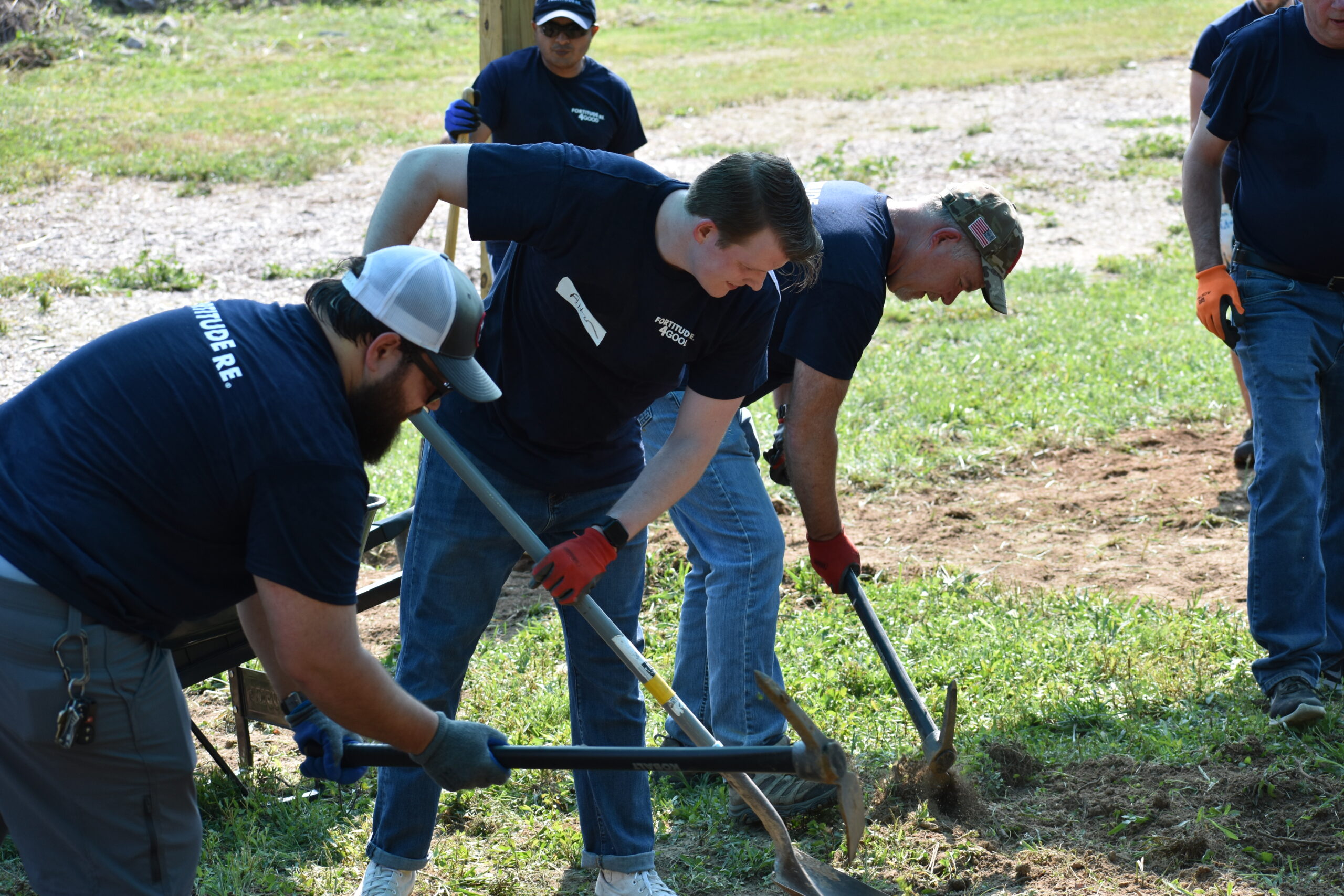 Colleagues working in a wooded area.