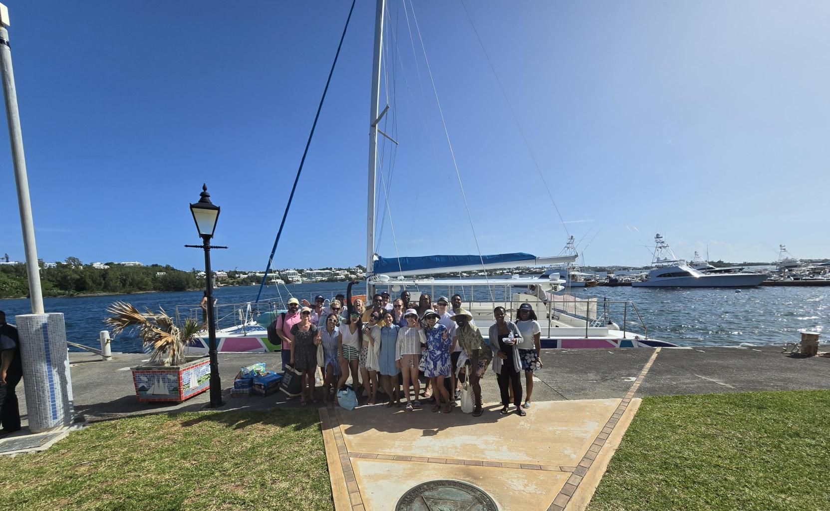 Colleagues standing in front of a boat in Bermuda.